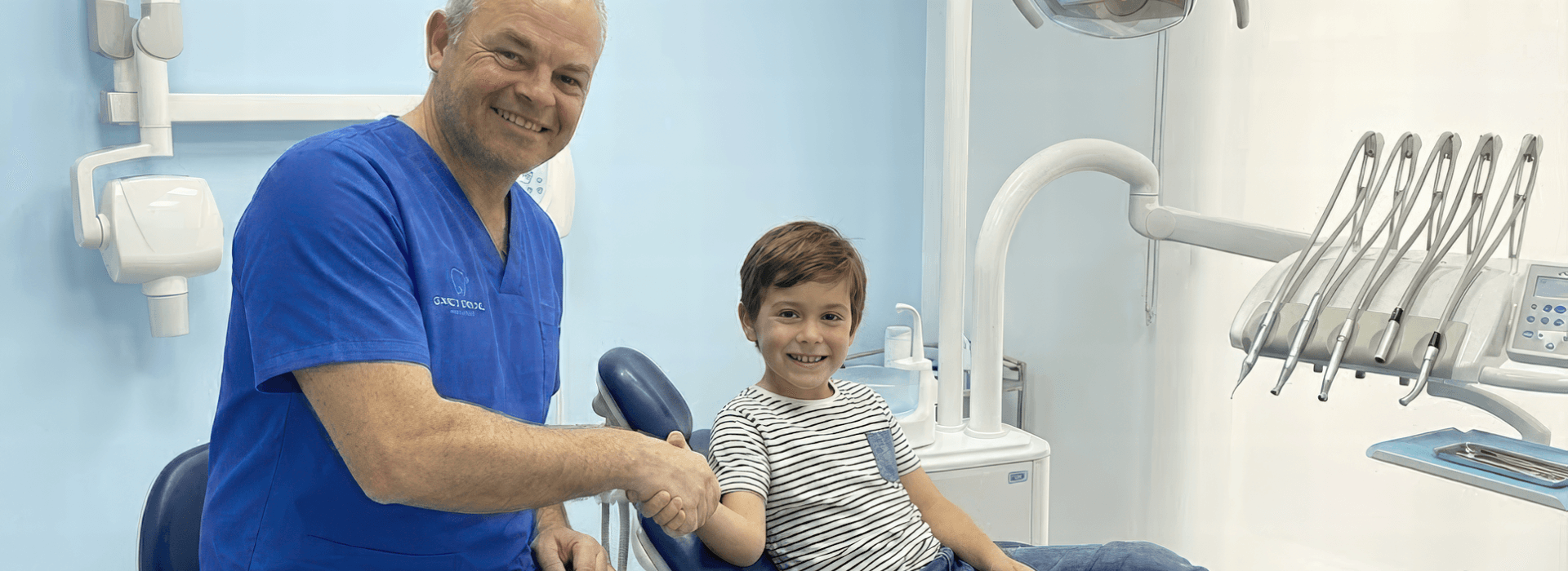 Mauro Grau holding a child's hand in the clinic
